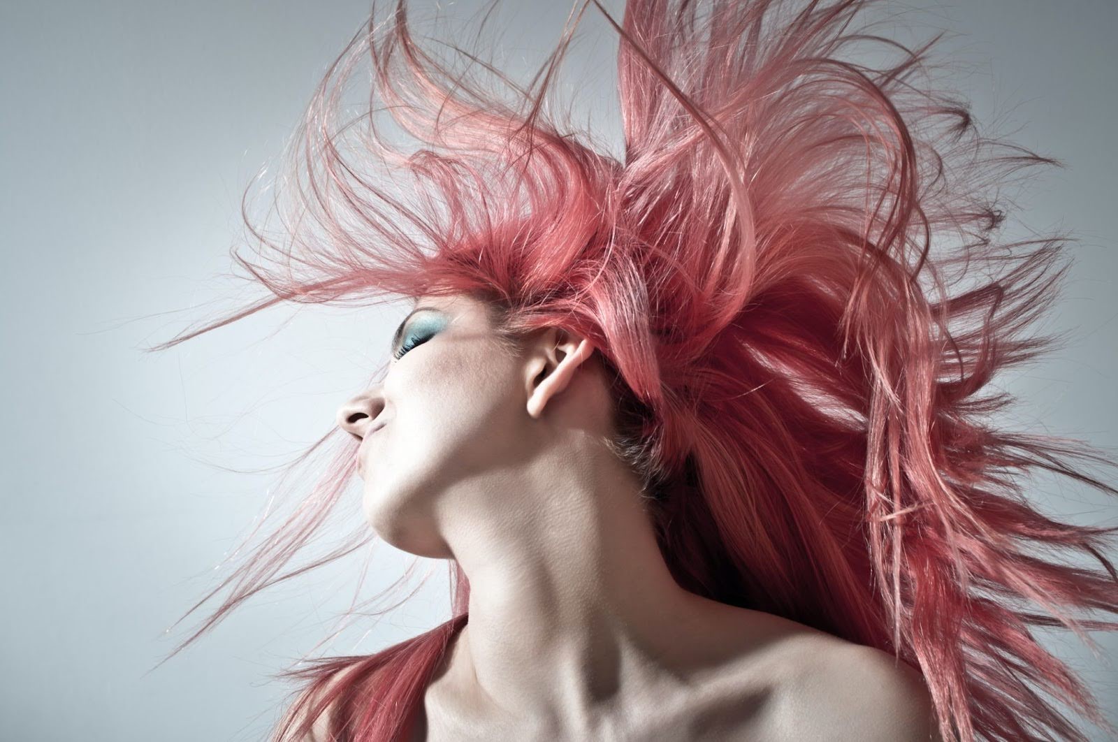 Expressive art photograph of a woman with flowing red hair